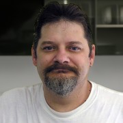 Man with short dark hair and mustache and a salt-and-pepper goatee